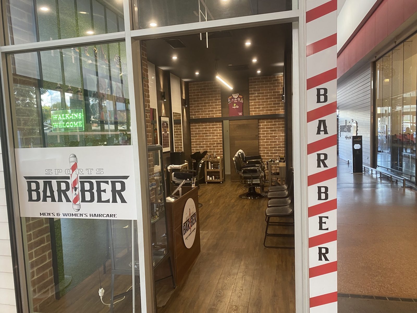 The Sports Barber shopfront at Northpoint with the Walk-ins Welcome sign lit up