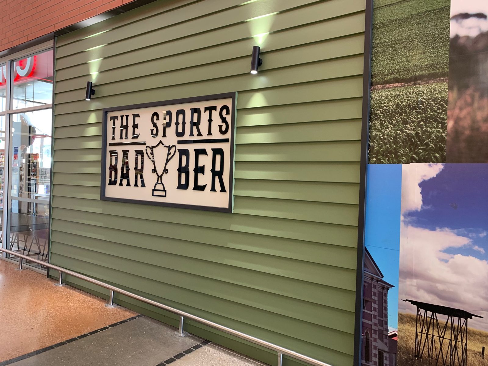 The Sports Barber sign on the green cladding outside the centre